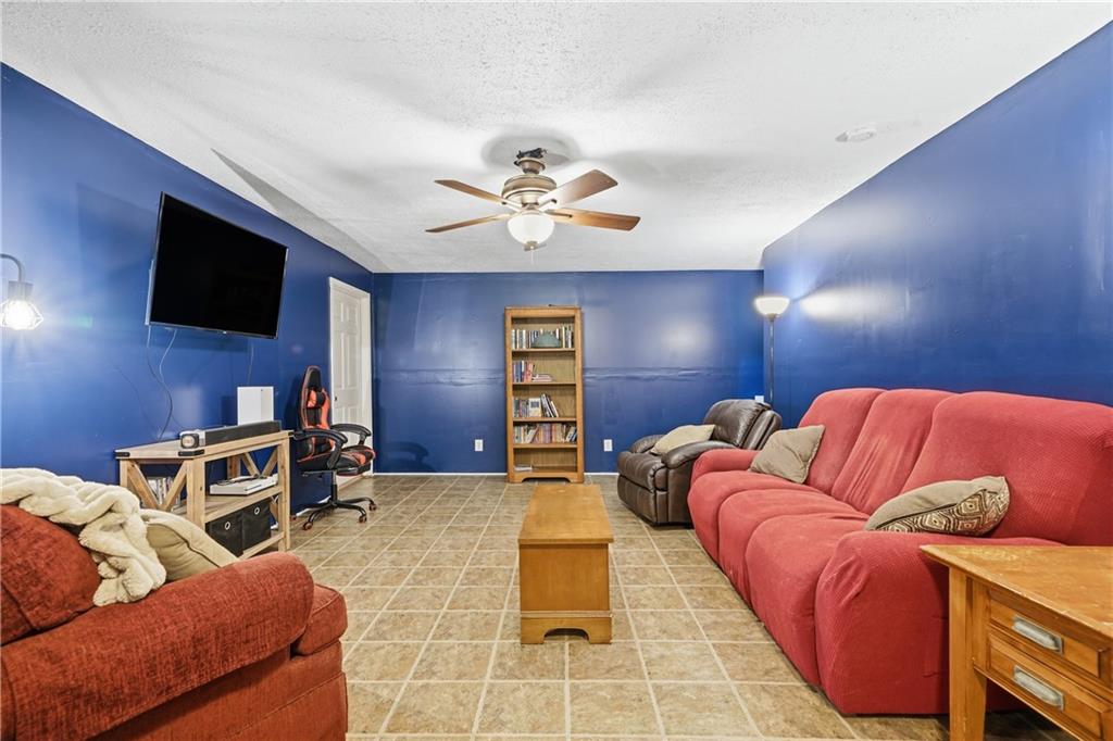 137 Orchard Way Southeast Calhoun, GA 30701 - Photo 36 of 39 a living room with furniture and a flat screen tv