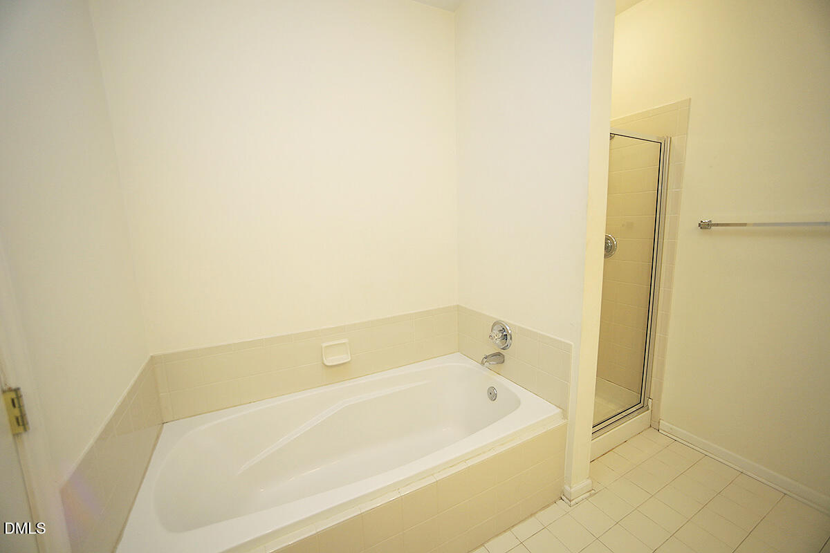 3161 Hemlock Forest Circle, Unit 101 Raleigh, NC 27612 - Photo 16 of 21 a bathroom with a bathtub
