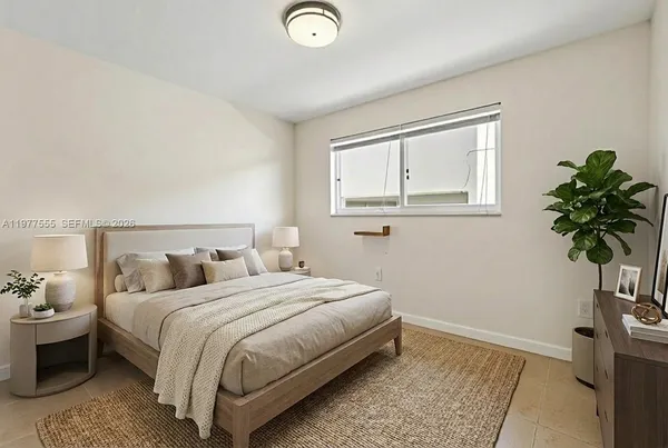 a bedroom with a bed and a potted plant