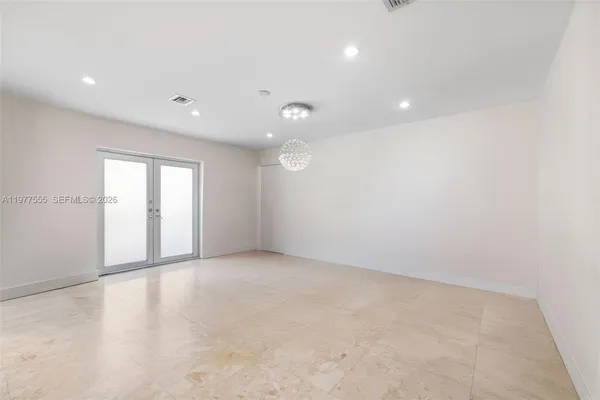 an empty room with windows and closet