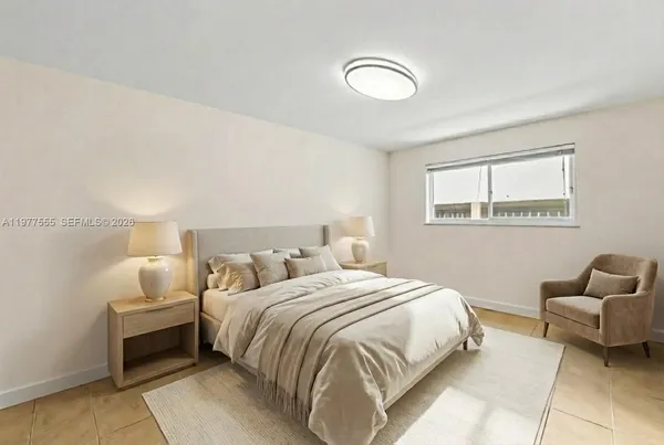 a bedroom with a bed and a couch