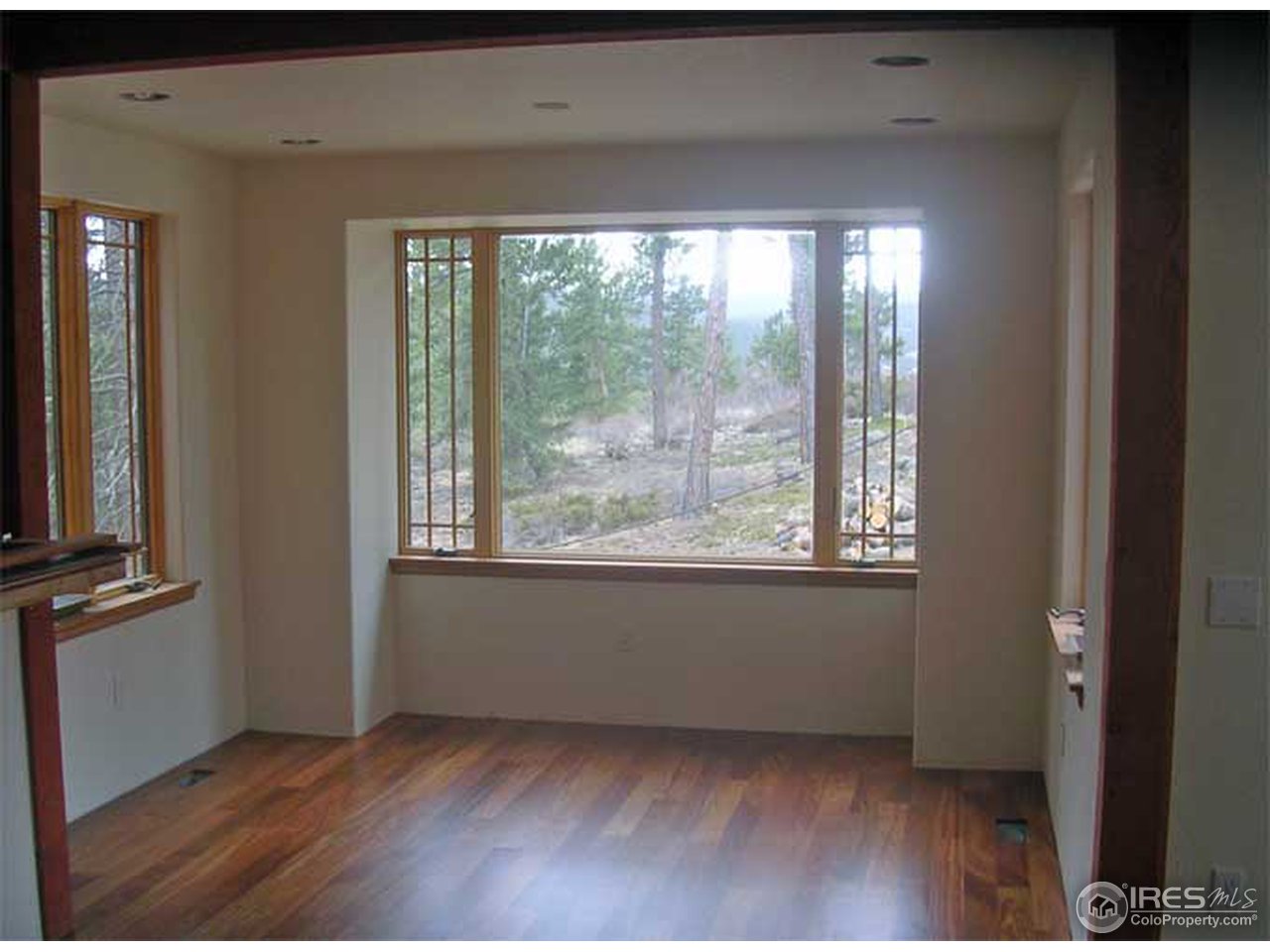 2607 Ridge Road Nederland, CO 80466 - Photo 7 of 18 a view of an empty room with wooden floor and a window