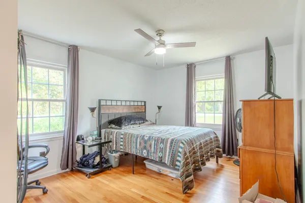 a bedroom with a bed window and a table