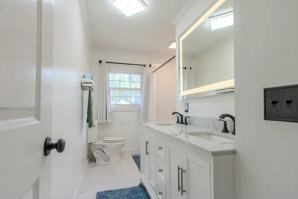 a bathroom with a double vanity sink and mirror