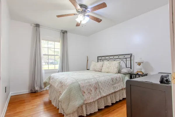 a bedroom with a bed and a ceiling fan