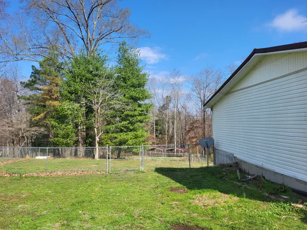 a view of backyard with a garden and trees