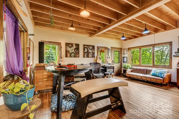 a living room with furniture a rug and a large window