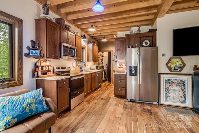 a kitchen with stainless steel appliances granite countertop a refrigerator and a stove