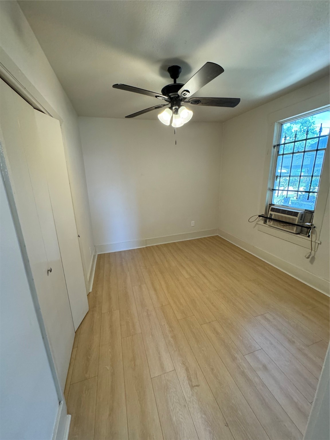 3428 Reeves Street Houston, TX 77004 - Photo 2 of 10 wooden floor in an empty room with a window