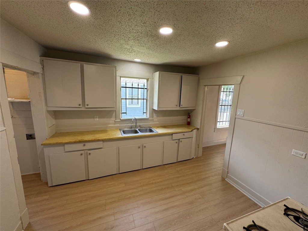 3428 Reeves Street Houston, TX 77004 - Photo 4 of 10 a large kitchen with lot of cabinets and wooden floor