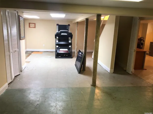 a view of a hallway with entryway and a window