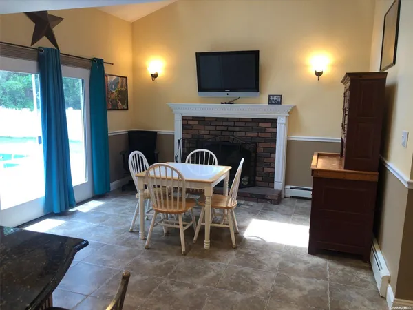 a view of a dining room with furniture window and fire place