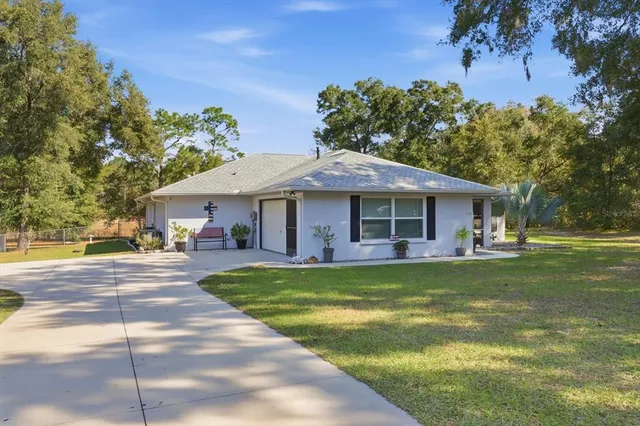 a view of a house with a swimming pool and a yard
