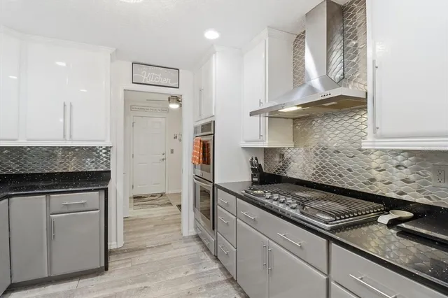 a kitchen with a stove and a refrigerator
