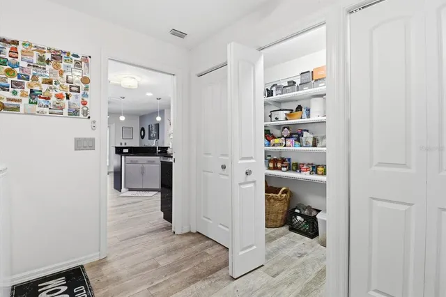 a kitchen with refrigerator and cabinets
