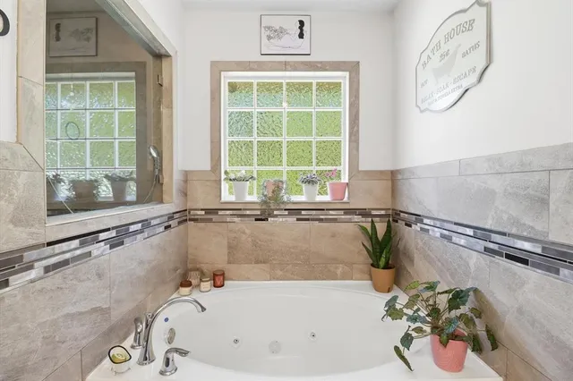 a bathroom with a tub and a window