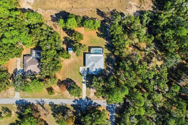 an aerial view of a houses with yard