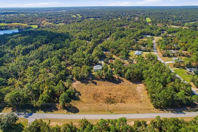 an aerial view of a houses with a yard