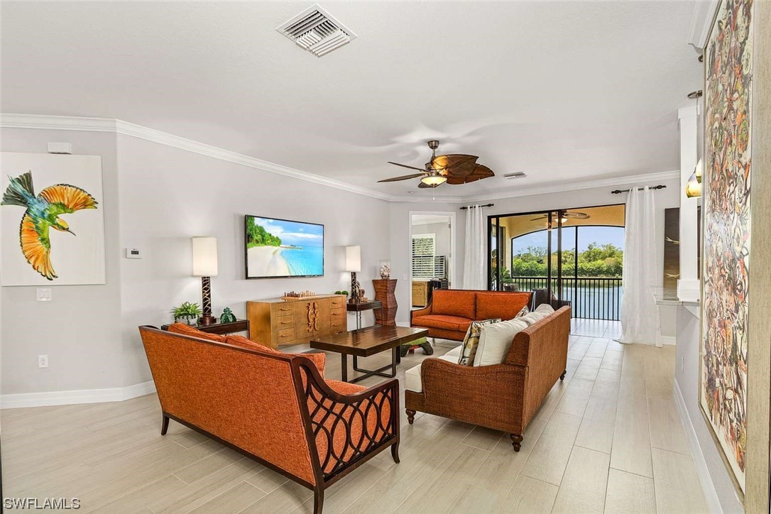 9490 Napoli Lane, Unit 202 Naples, FL 34113 - Photo 14 of 24 a living room with furniture and a table