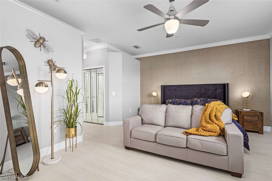 9490 Napoli Lane, Unit 202 Naples, FL 34113 - Photo 16 of 24 a living room with furniture a ceiling fan and a rug