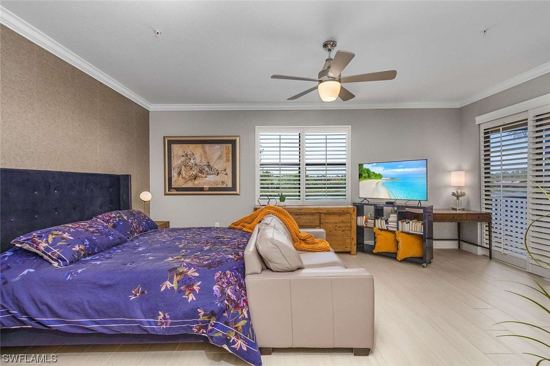 9490 Napoli Lane, Unit 202 Naples, FL 34113 - Photo 17 of 24 a bedroom with a bed and wooden floor