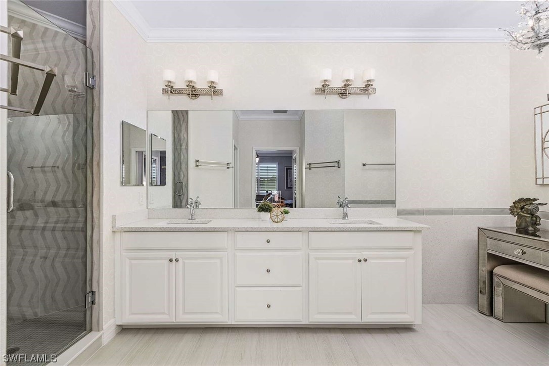 9490 Napoli Lane, Unit 202 Naples, FL 34113 - Photo 18 of 24 a bathroom with a sink double vanity and a mirror
