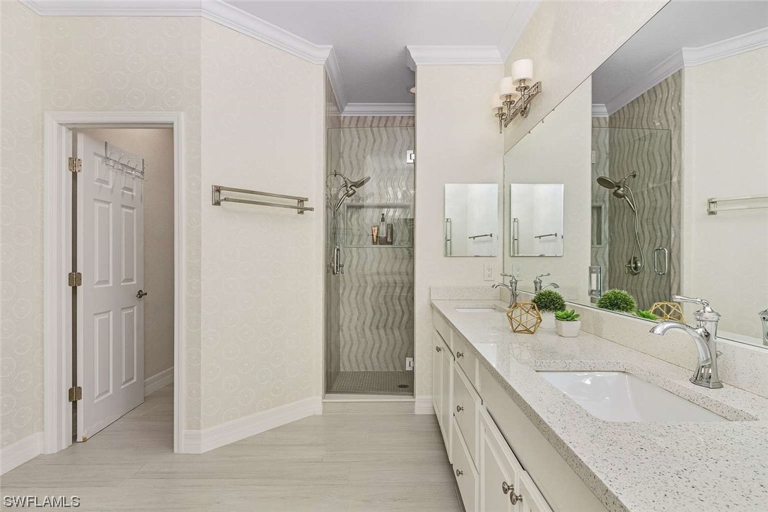 9490 Napoli Lane, Unit 202 Naples, FL 34113 - Photo 19 of 24 a bathroom with a granite countertop double vanity sink a mirror and a shower