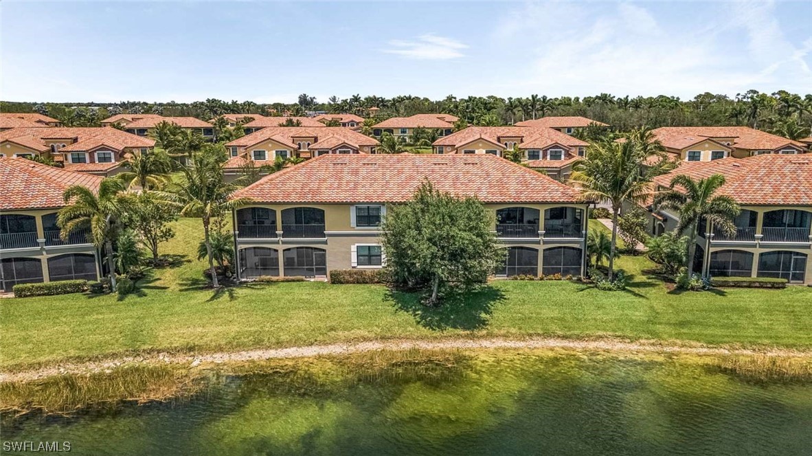 9490 Napoli Lane, Unit 202 Naples, FL 34113 - Photo 24 of 24 a view of a house with a big yard