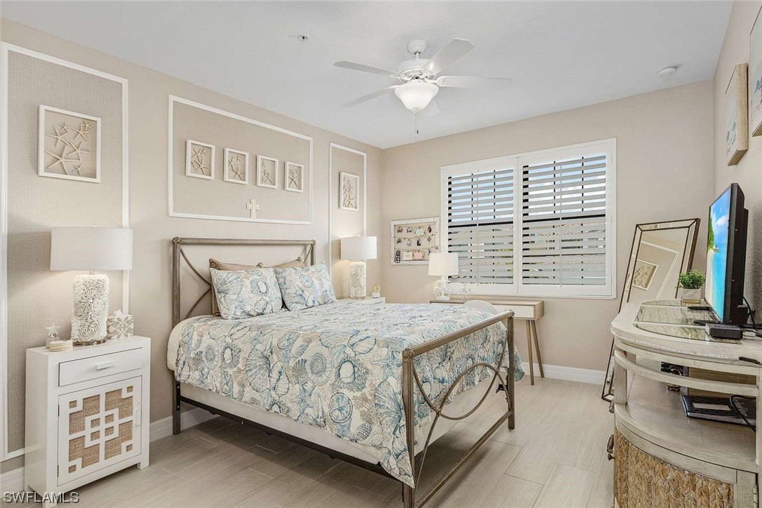 9490 Napoli Lane, Unit 202 Naples, FL 34113 - Photo 3 of 24 a bedroom with a bed furniture and a window