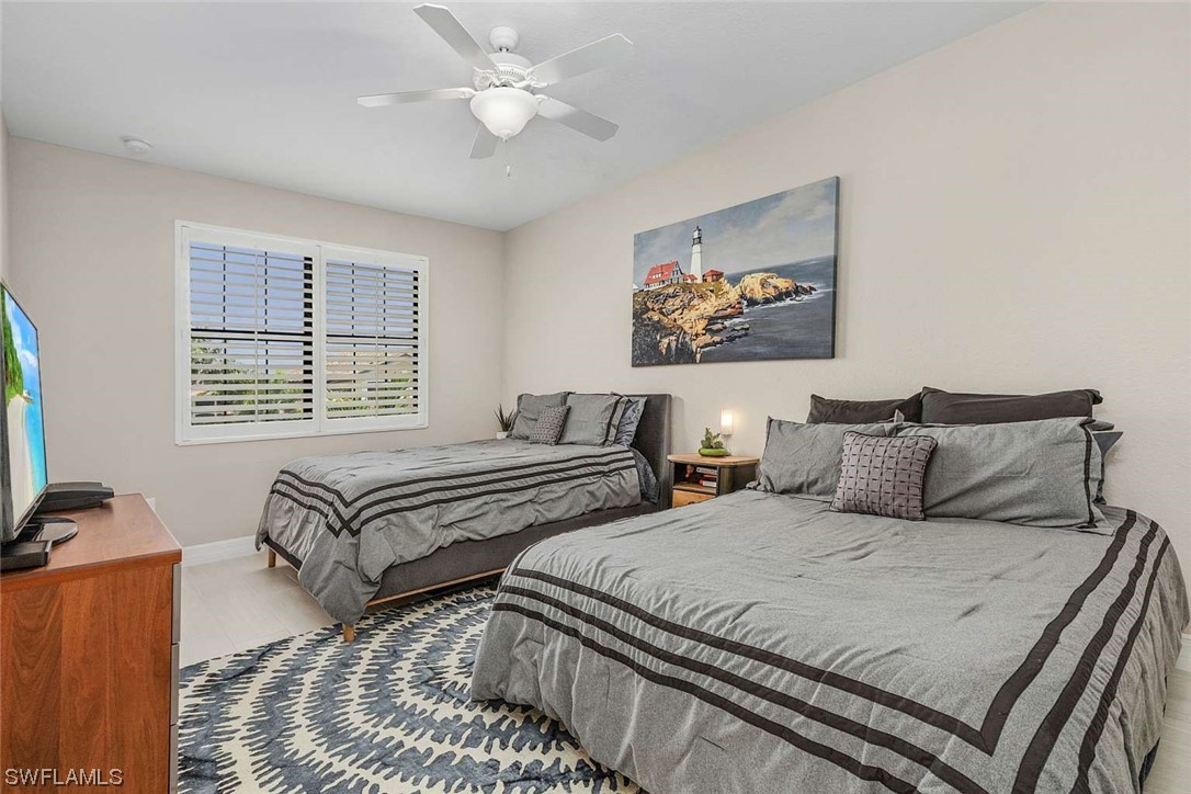 9490 Napoli Lane, Unit 202 Naples, FL 34113 - Photo 4 of 24 a bedroom with bed and a window