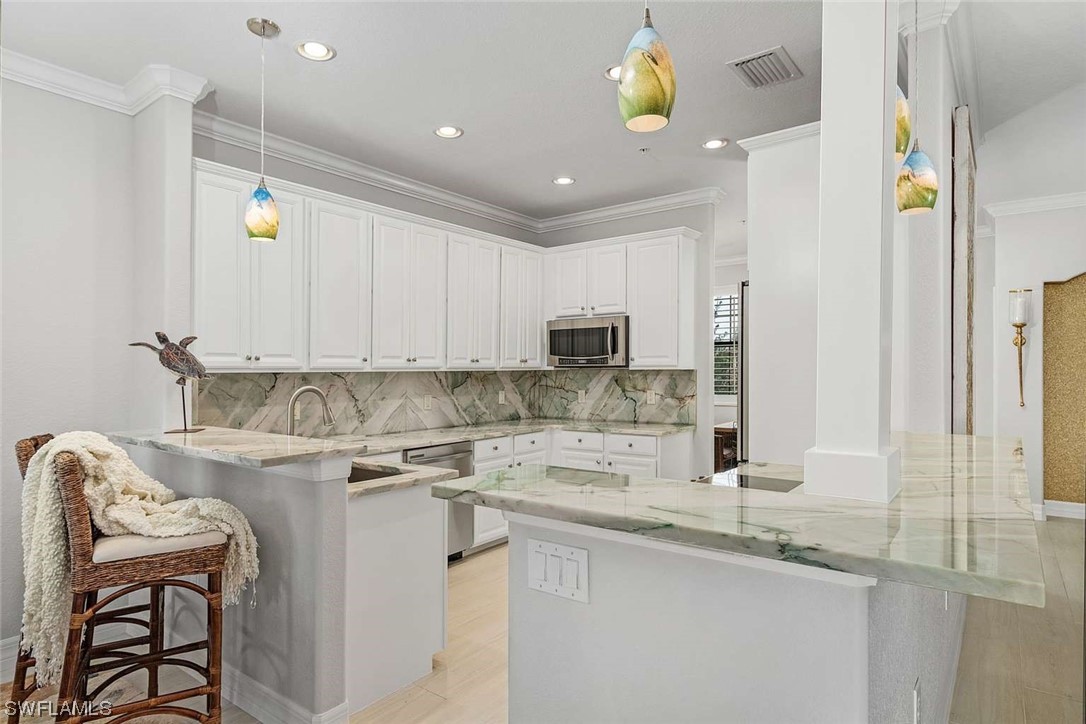 9490 Napoli Lane, Unit 202 Naples, FL 34113 - Photo 10 of 24 a kitchen with a sink cabinets and window