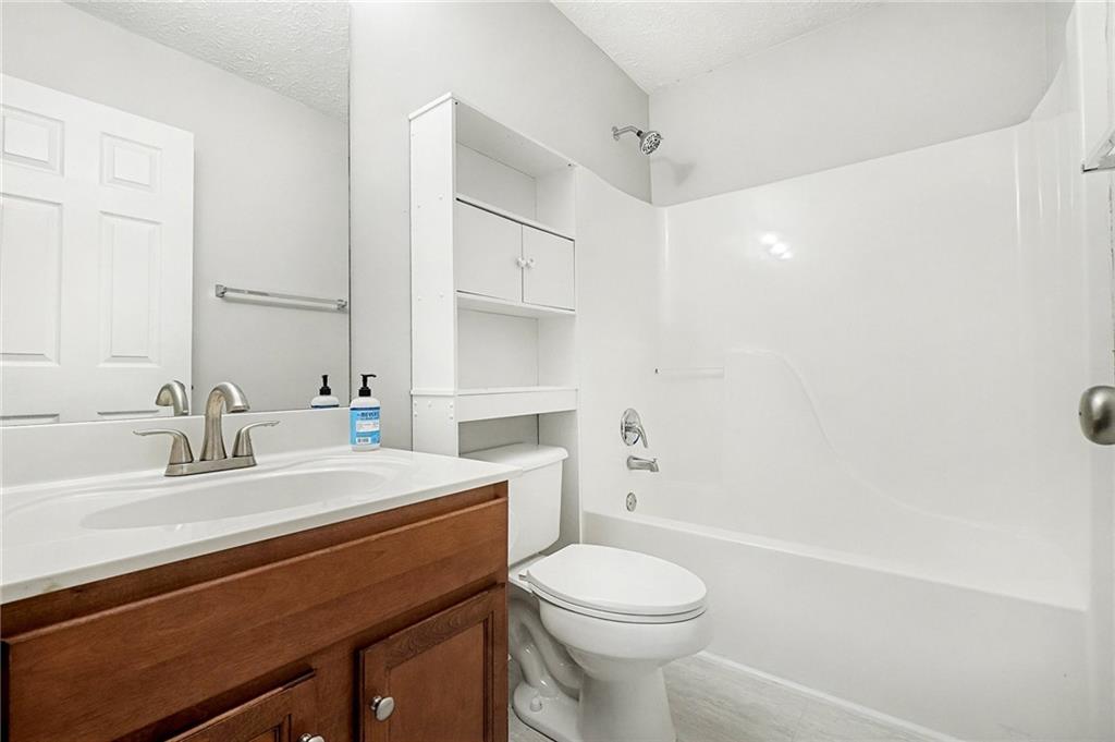 307 Remington Pl Boulevard Dallas, GA 30157 - Photo 11 of 27 a bathroom with a sink a toilet and shower
