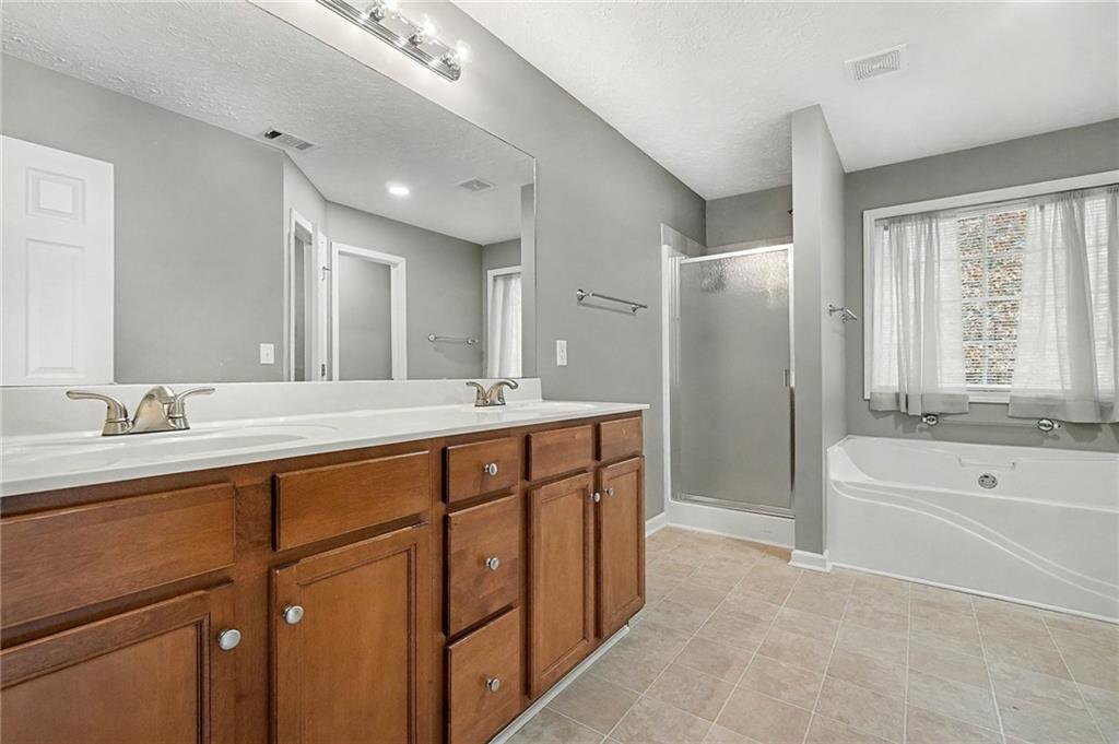 307 Remington Pl Boulevard Dallas, GA 30157 - Photo 17 of 27 a spacious bathroom with a tub sink and mirror