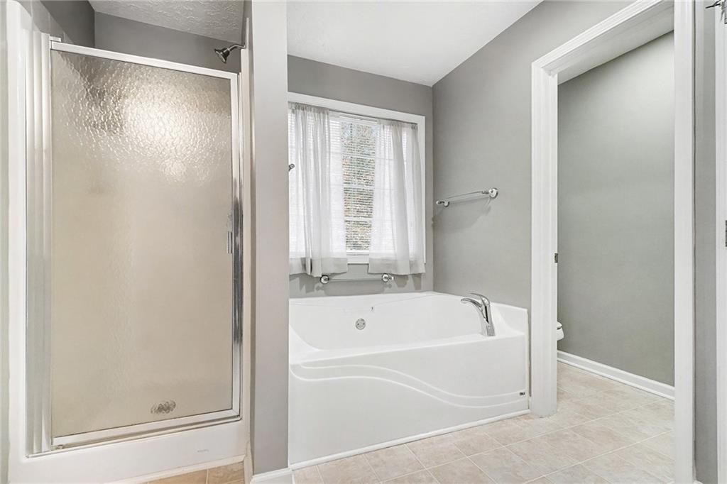307 Remington Pl Boulevard Dallas, GA 30157 - Photo 18 of 27 a white bath tub with a shower