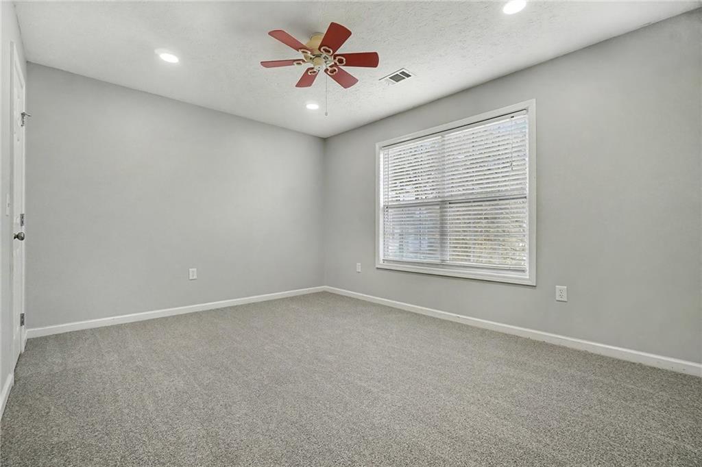 307 Remington Pl Boulevard Dallas, GA 30157 - Photo 20 of 27 an empty room with a window and a fan