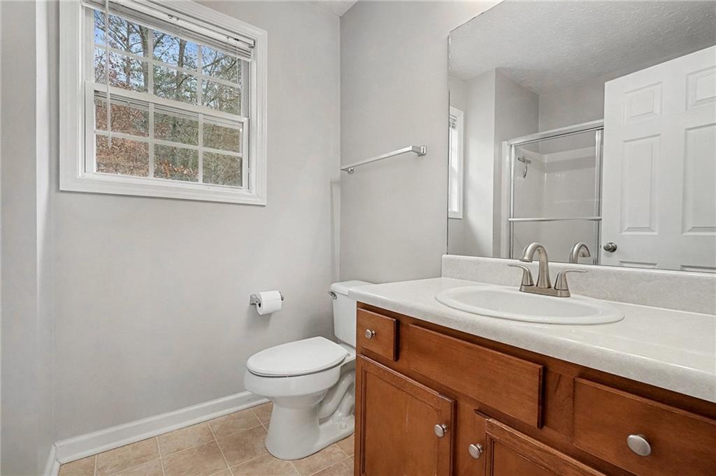 307 Remington Pl Boulevard Dallas, GA 30157 - Photo 22 of 27 a bathroom with a toilet sink and mirror