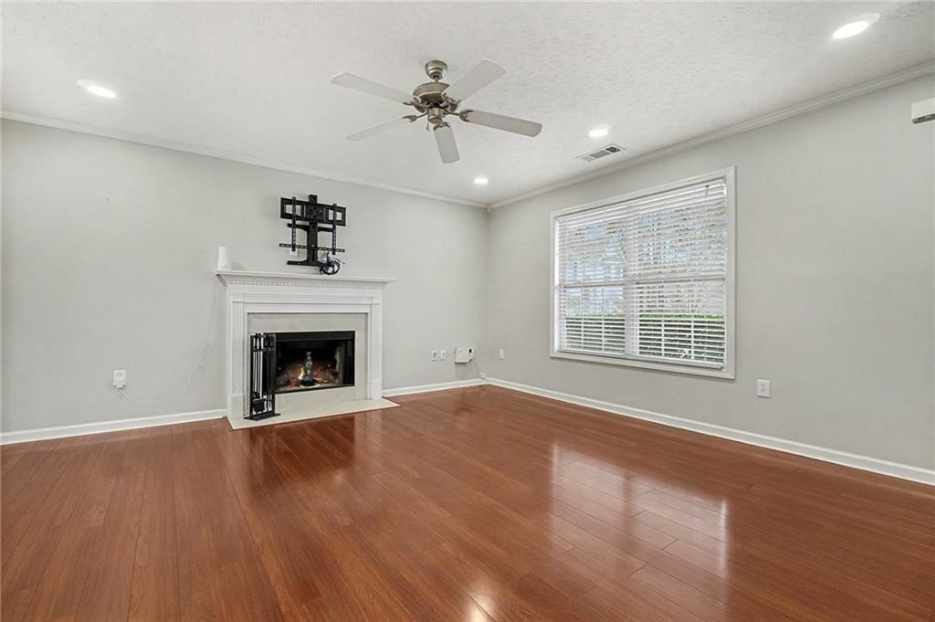 307 Remington Pl Boulevard Dallas, GA 30157 - Photo 5 of 27 a view of an empty room with wooden floor fireplace and a window