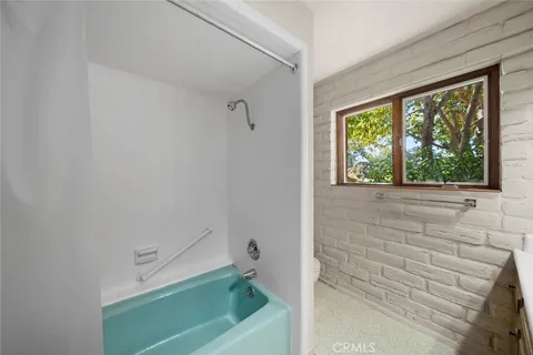 a white toilet sitting next to a bathroom sink and vanity