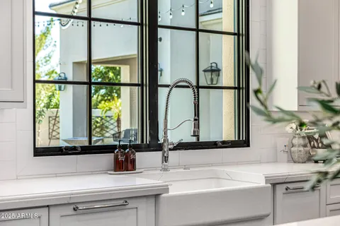 a bathroom with a granite countertop toilet a sink a shower and a mirror