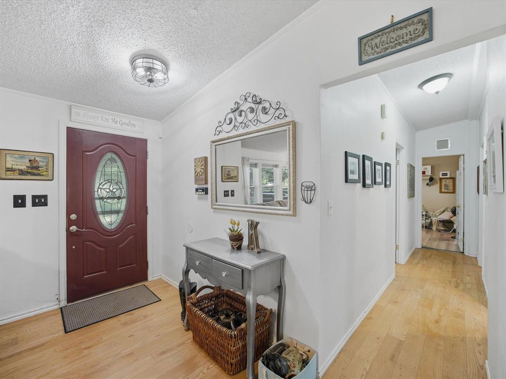 3275 Finis Road Graham, TX 76450 - Photo 5 of 36 a view of a hallway with wooden floor and workspace
