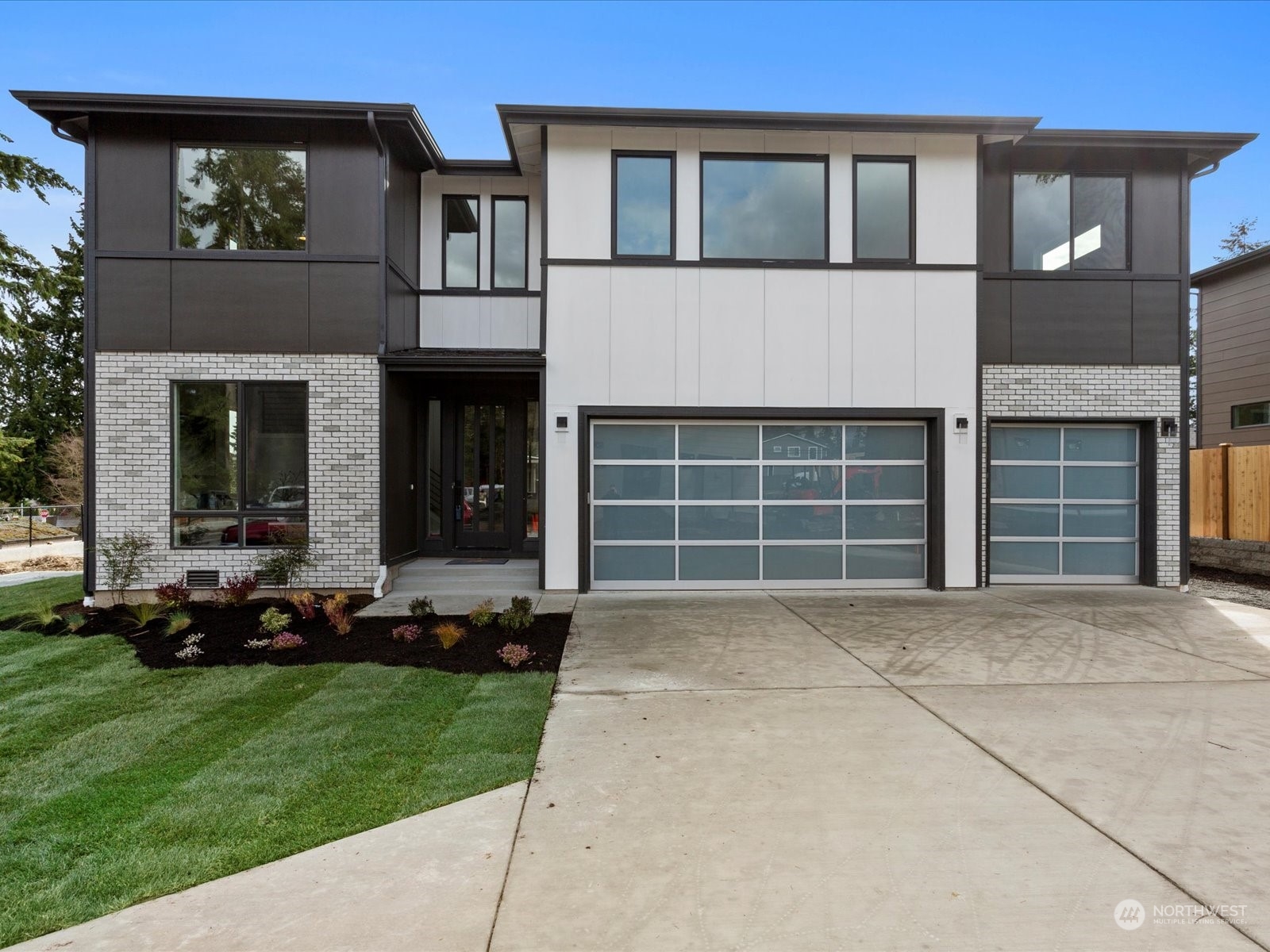 21609 1st Avenue West Bothell, WA 98021 - Photo 1 of 40 a front view of a house with a garden and plants