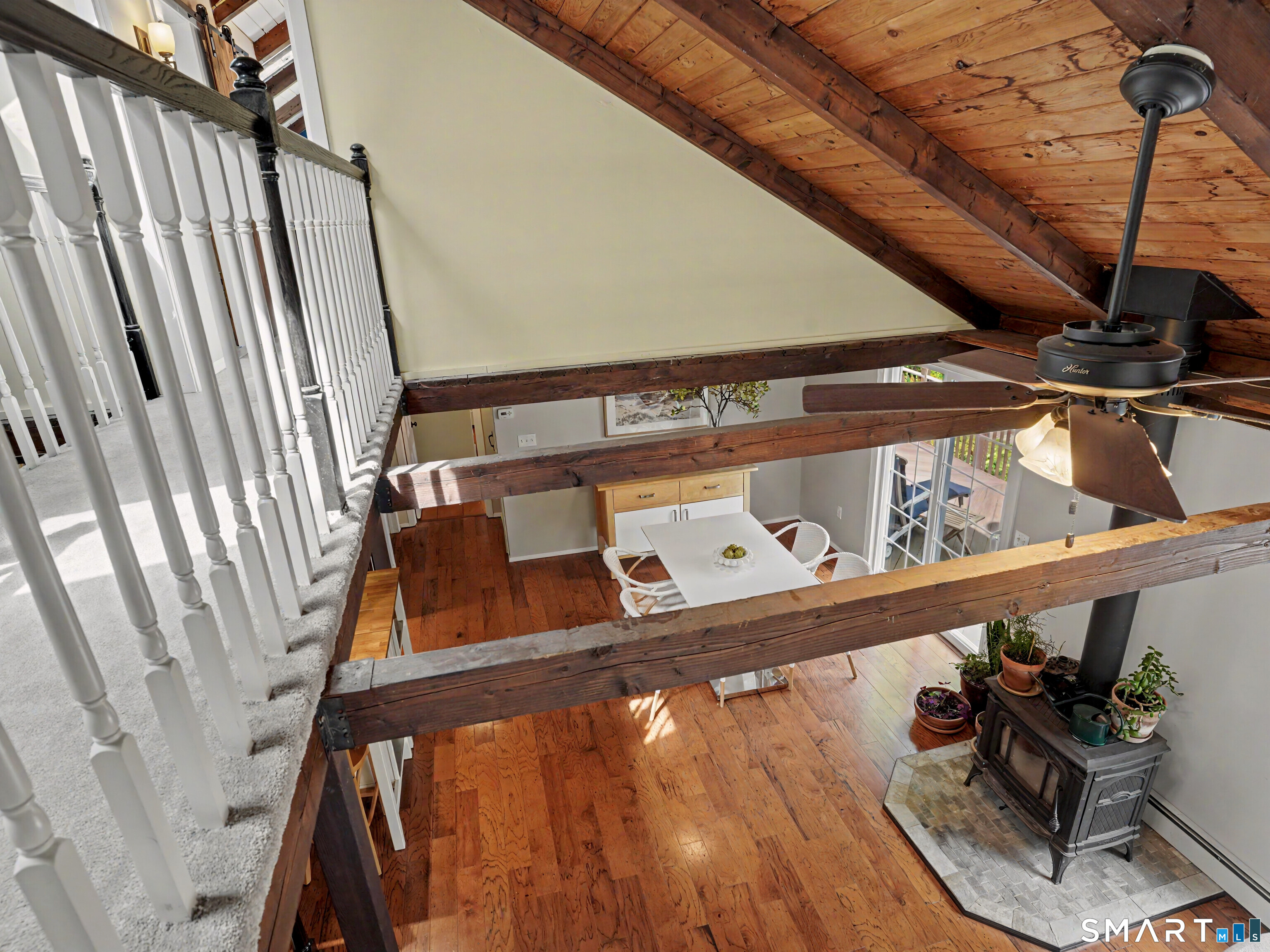 252 Bennetts Farm Road Ridgefield, CT 06877 - Photo 18 of 40 Views of the hard wood floors, Wood-Burning Stove & Kitchen Eating Area from the Loft, above.