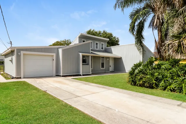 a front view of a house with a garden and entryway