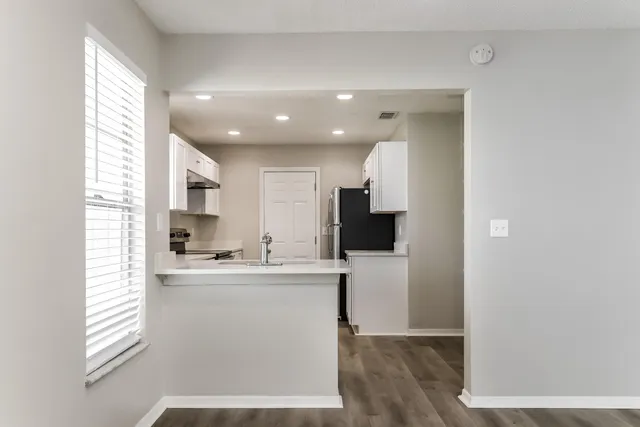 a kitchen with kitchen island a sink stainless steel appliances and cabinets