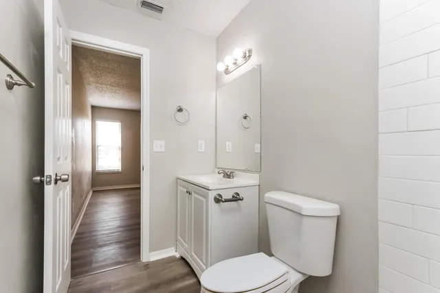 a white toilet sitting next to a bathroom sink