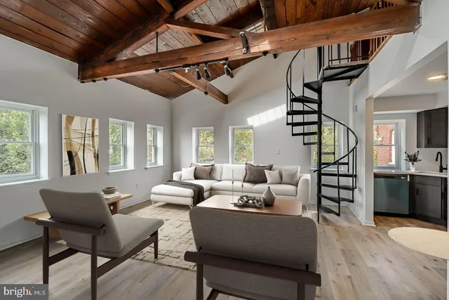 a living room with furniture a ceiling fan and a rug
