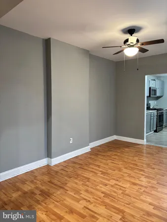 a kitchen with stainless steel appliances granite countertop grey cabinets and stove