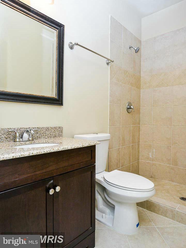 8536 Old Keene Mill Road Springfield, VA 22152 - Photo 24 of 30 a bathroom with a sink a toilet and shower