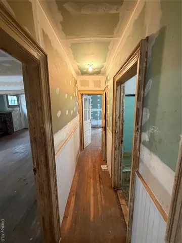 a view of hallway with wooden floor