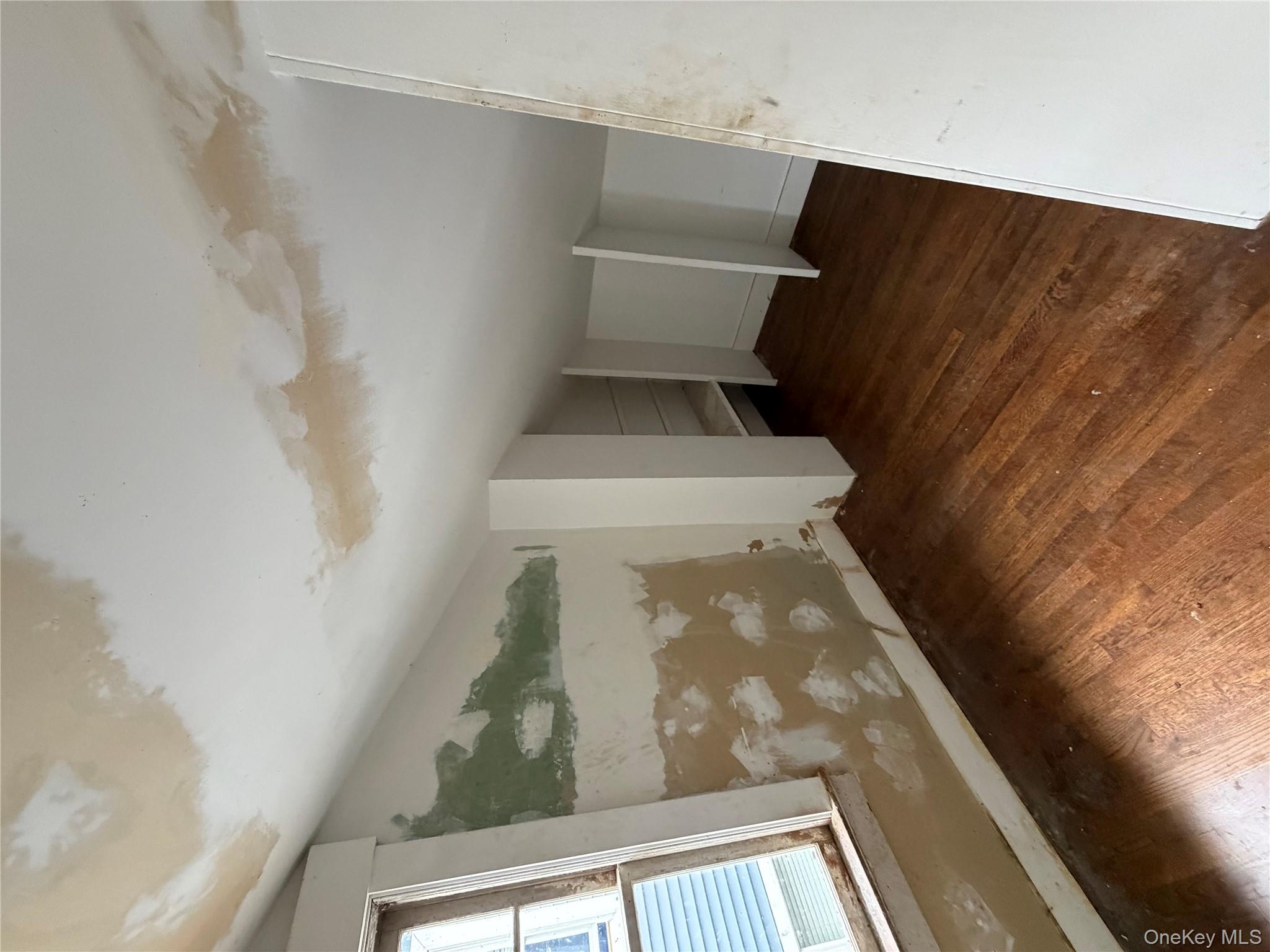 244 Tibbetts Road Yonkers, NY 10705 - Photo 5 of 28 a view of an empty room with wooden floor and a window